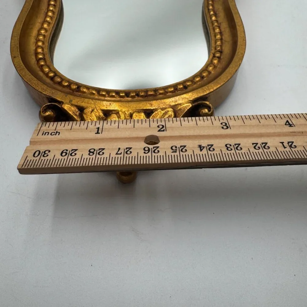 French-style ornate wall mirror, rococo or baroque decorative elements in a gil